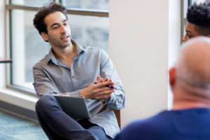 A case manager meets with a group of clients.