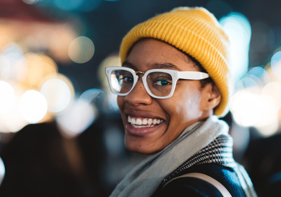 A portrait of a young black African American woman while looking at the camera.